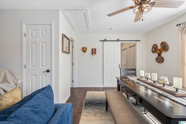 interior space with a barn door and dark wood-type flooring