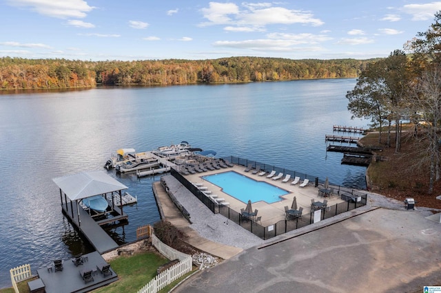 exterior space featuring a water view and a community pool