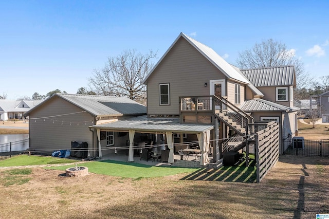 back of house featuring a fire pit, a lawn, a patio area, and central air condition unit