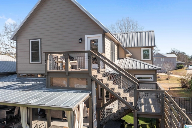 rear view of property featuring a wooden deck