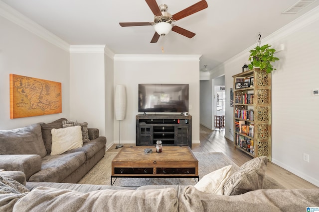 living room with light wood-type flooring, ceiling fan, and crown molding