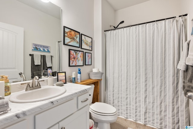 bathroom featuring vanity, a shower with shower curtain, and toilet