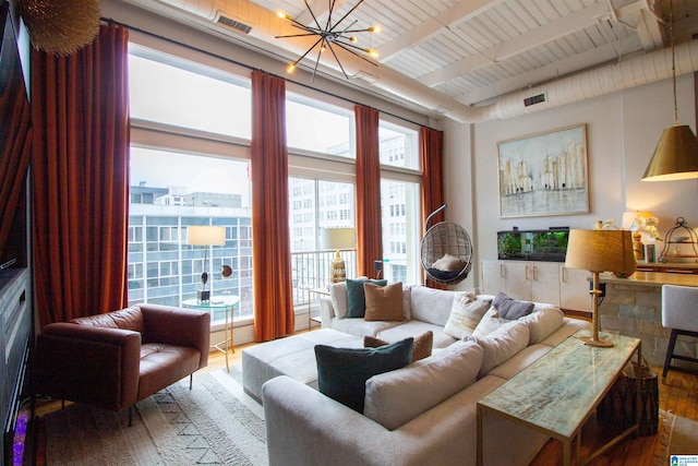 living room featuring sink, beamed ceiling, a chandelier, wood-type flooring, and wood ceiling