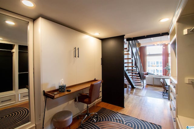 office area with light hardwood / wood-style flooring and built in desk