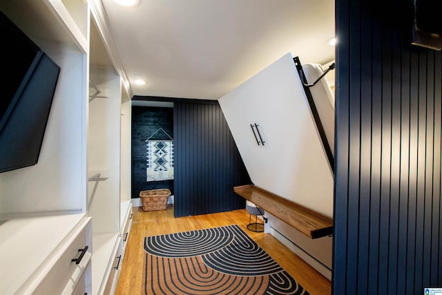 interior space with light hardwood / wood-style floors and ornamental molding