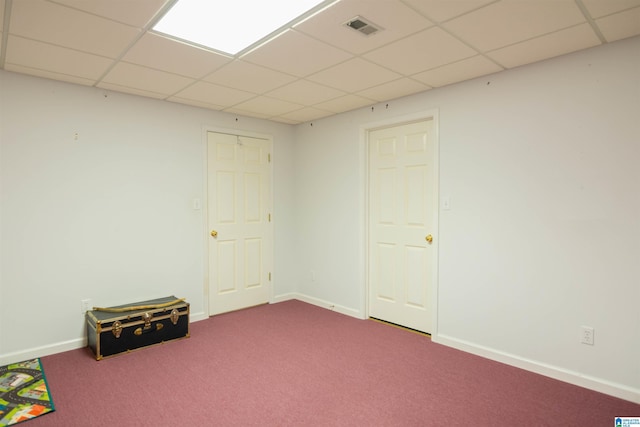 basement featuring carpet flooring and a drop ceiling