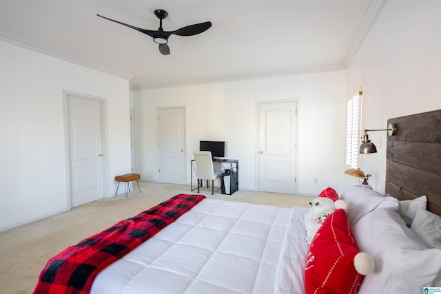 carpeted bedroom featuring ceiling fan and crown molding