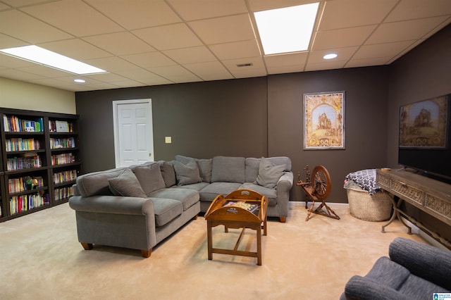 carpeted living room featuring a paneled ceiling