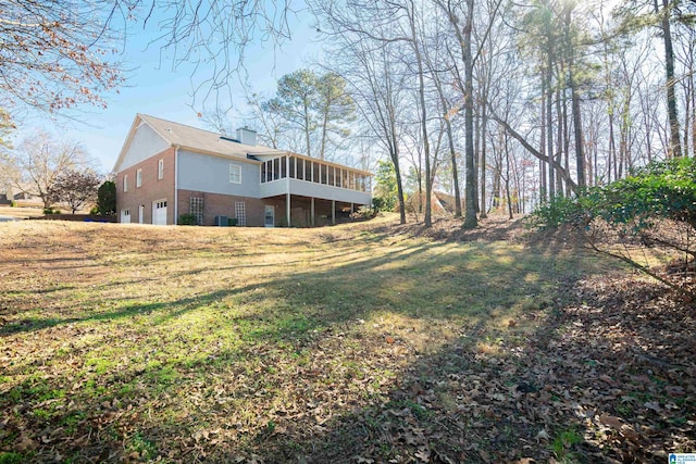 view of yard featuring a sunroom