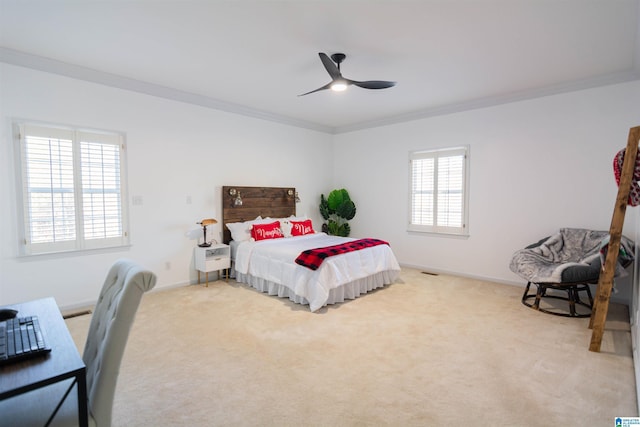 carpeted bedroom with ceiling fan and ornamental molding