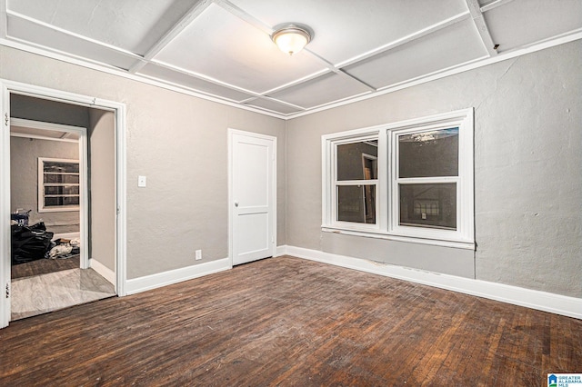 unfurnished room featuring coffered ceiling and dark hardwood / wood-style floors