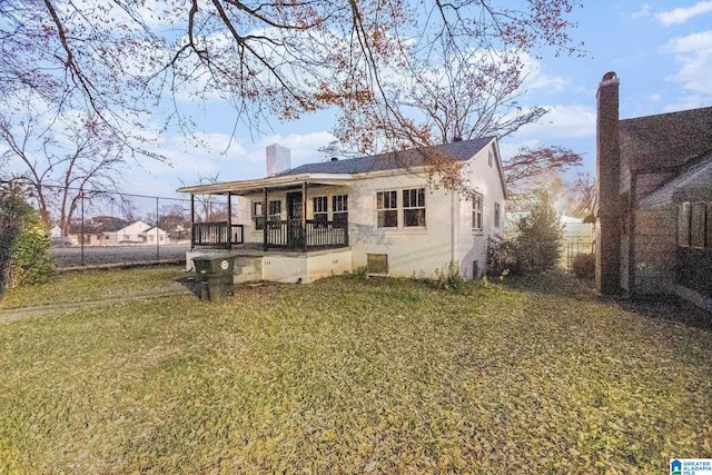 back of house with a lawn and a porch