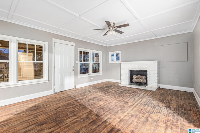 unfurnished living room with ceiling fan, dark hardwood / wood-style floors, a fireplace, and coffered ceiling