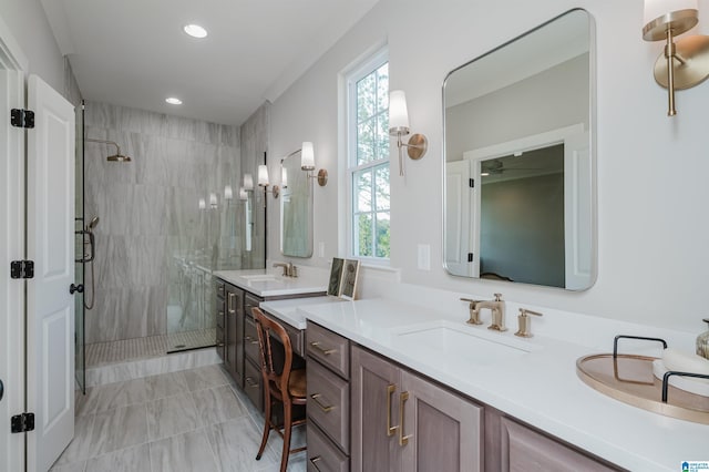 bathroom featuring a shower with door and vanity