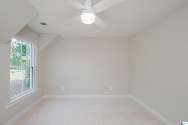 additional living space featuring ceiling fan and light carpet