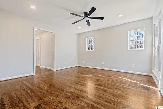 spare room with ceiling fan and dark wood-type flooring