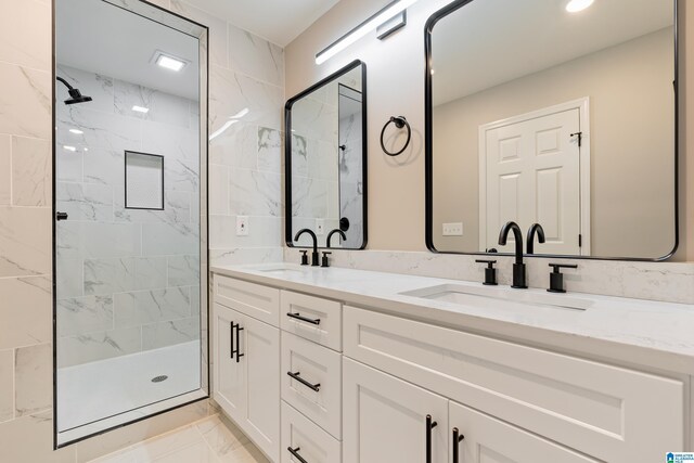 bathroom featuring vanity and tiled shower