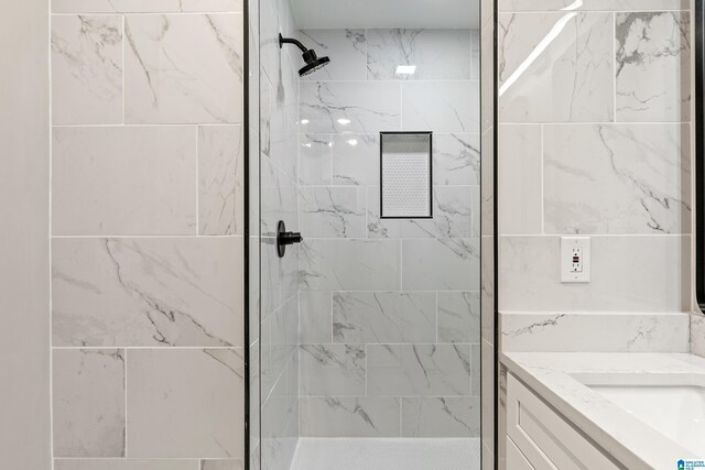 bathroom featuring vanity and tiled shower