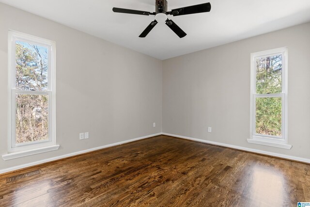 unfurnished room featuring hardwood / wood-style floors, plenty of natural light, and ceiling fan