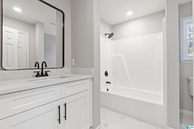 full bathroom with toilet, vanity, and tub / shower combination