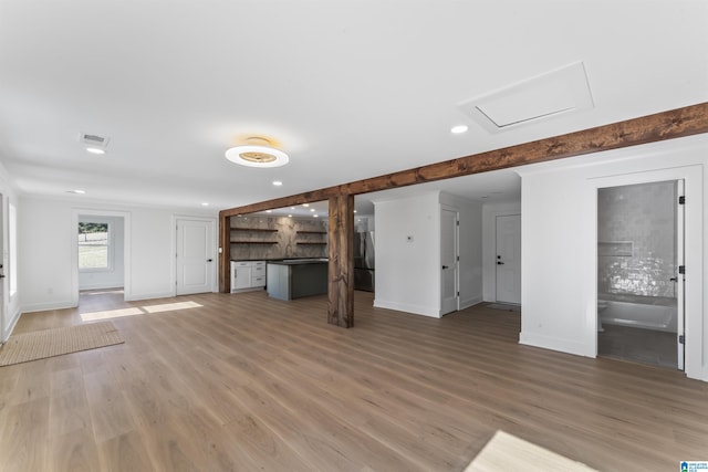 unfurnished living room featuring hardwood / wood-style floors