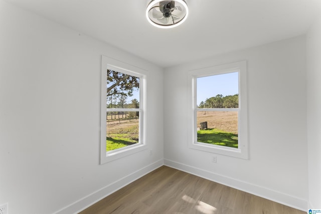 spare room with hardwood / wood-style flooring and a healthy amount of sunlight