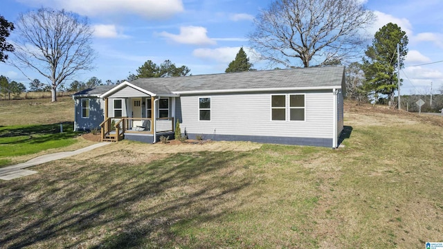 manufactured / mobile home with a front yard and covered porch