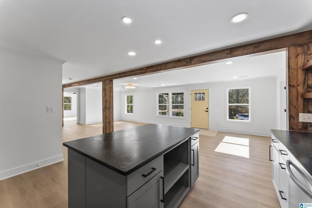 kitchen featuring beam ceiling, light hardwood / wood-style floors, dishwasher, and a kitchen island