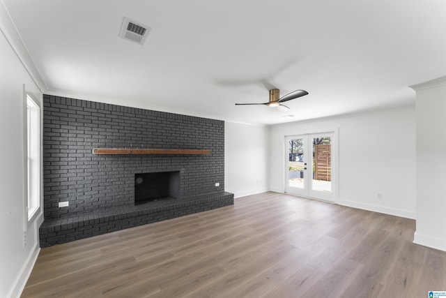 unfurnished living room with a fireplace, light hardwood / wood-style flooring, ornamental molding, and ceiling fan