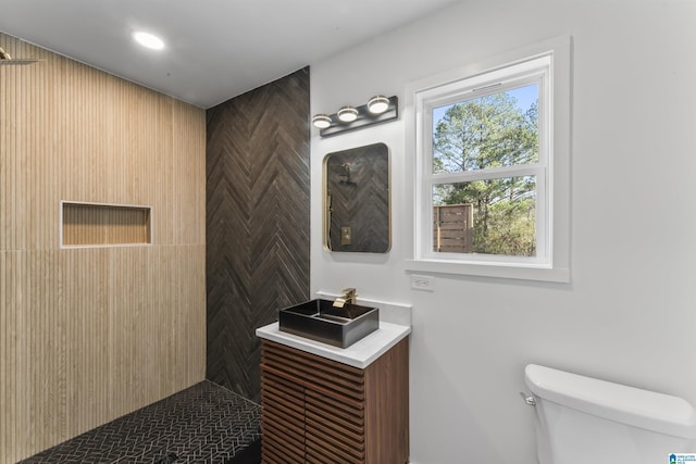 bathroom featuring tiled shower and toilet