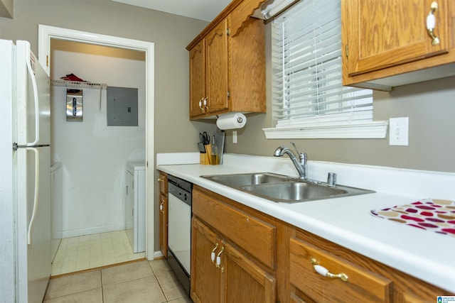 kitchen featuring electric panel, sink, dishwashing machine, white fridge, and washer / dryer