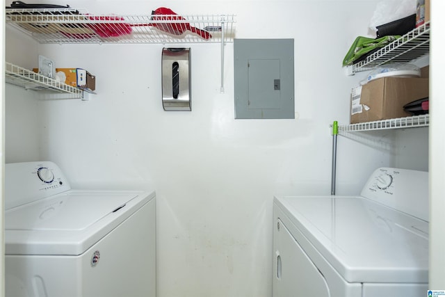 clothes washing area featuring independent washer and dryer and electric panel