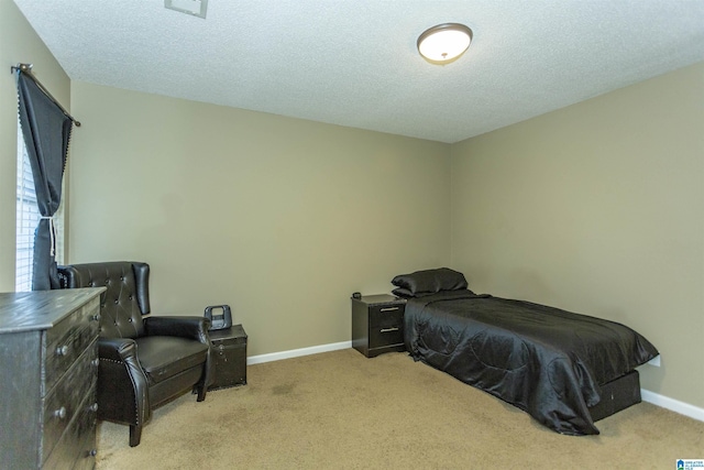 carpeted bedroom with a textured ceiling