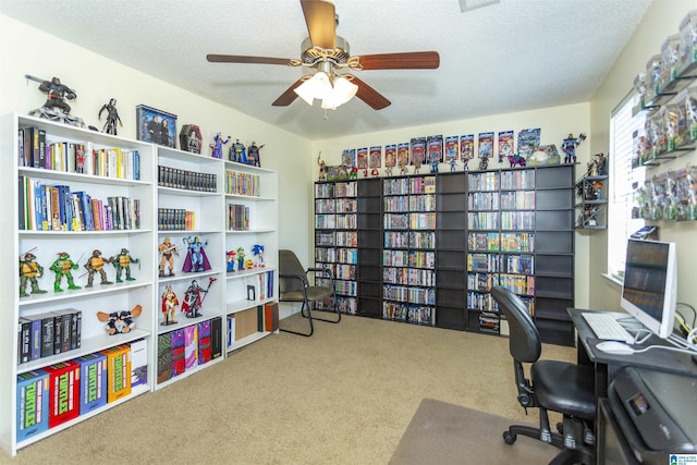 carpeted home office with ceiling fan and a textured ceiling