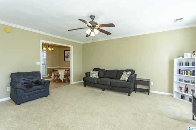 living room with ceiling fan with notable chandelier, light colored carpet, and ornamental molding