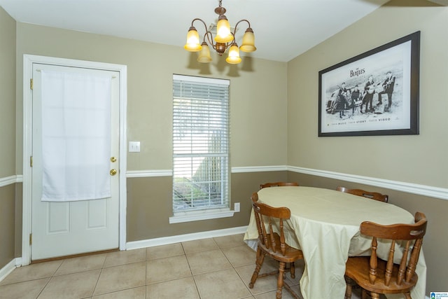 tiled dining room featuring an inviting chandelier