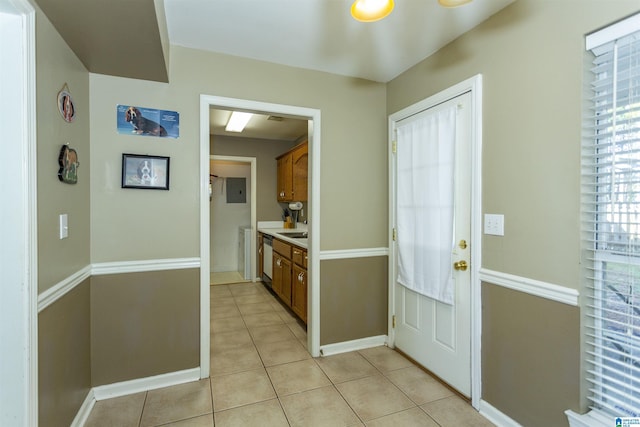 entryway with sink and light tile patterned flooring