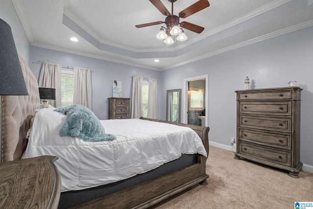 bedroom featuring a tray ceiling, ceiling fan, crown molding, and light colored carpet