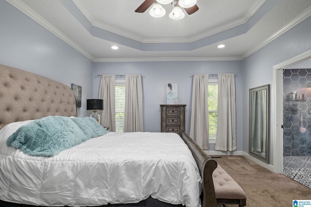 bedroom featuring ceiling fan, carpet floors, crown molding, and a tray ceiling