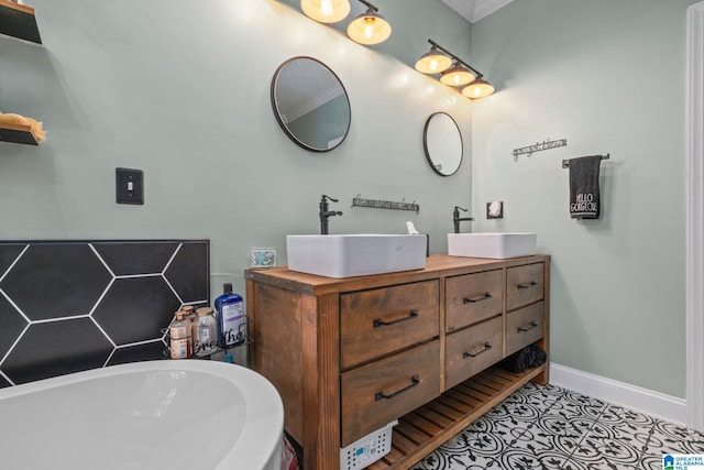 bathroom with tile patterned flooring, vanity, and crown molding