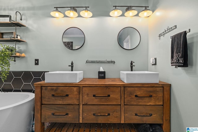 bathroom with vanity and a washtub