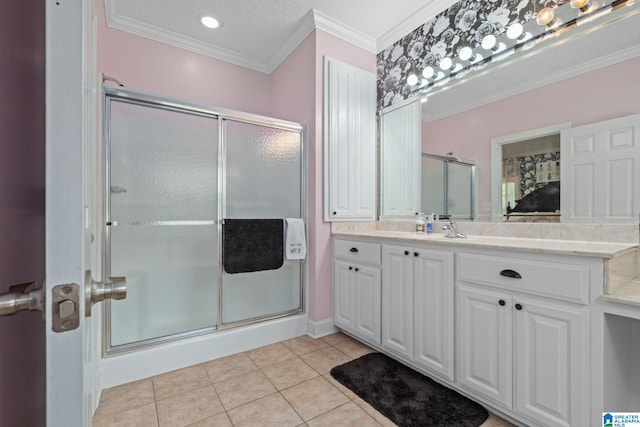 bathroom featuring vanity, tile patterned floors, a shower with door, and crown molding