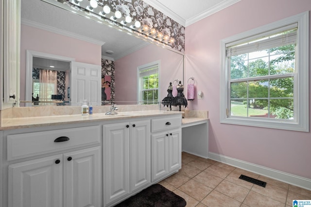 bathroom featuring tile patterned floors, crown molding, vanity, and a healthy amount of sunlight