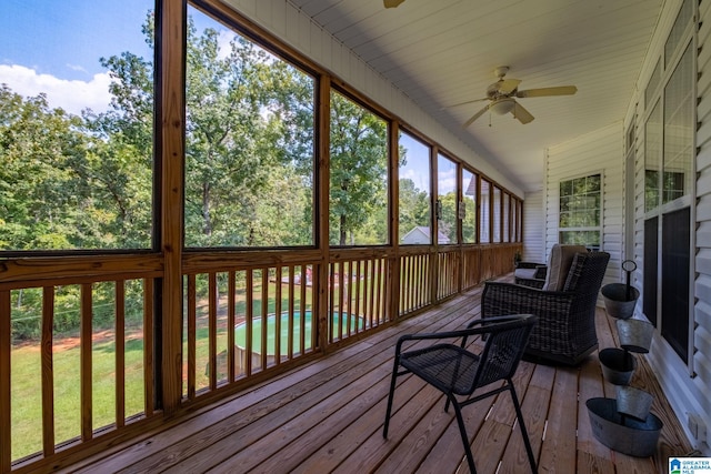 sunroom / solarium featuring ceiling fan