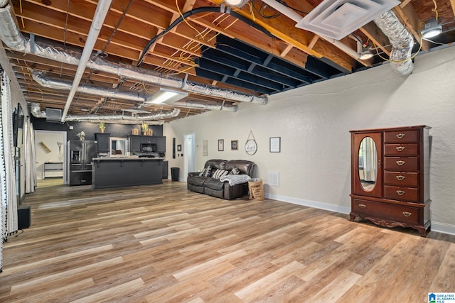 basement featuring hardwood / wood-style floors and high end fridge