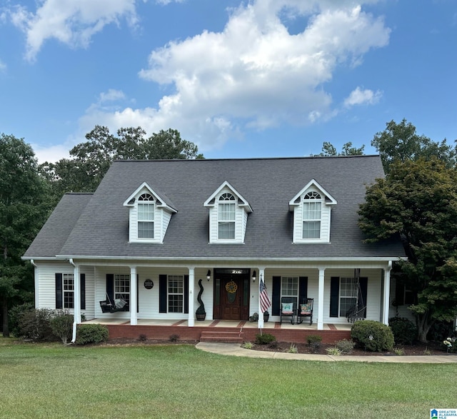 cape cod house with a front lawn and a porch