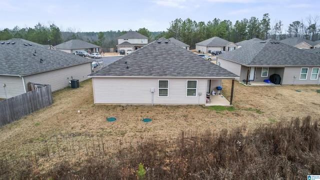 back of property featuring a lawn, a patio area, and cooling unit