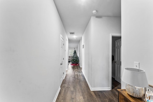 corridor with dark hardwood / wood-style flooring