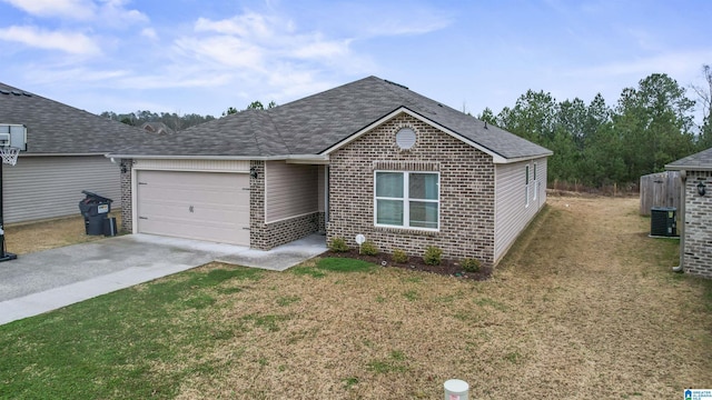 ranch-style home with a front yard, a garage, and central AC unit