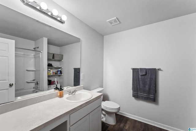 full bathroom with shower / tub combination, vanity, toilet, and hardwood / wood-style floors